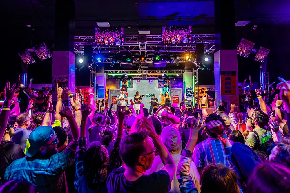 A crowd facing the main stage during a live show